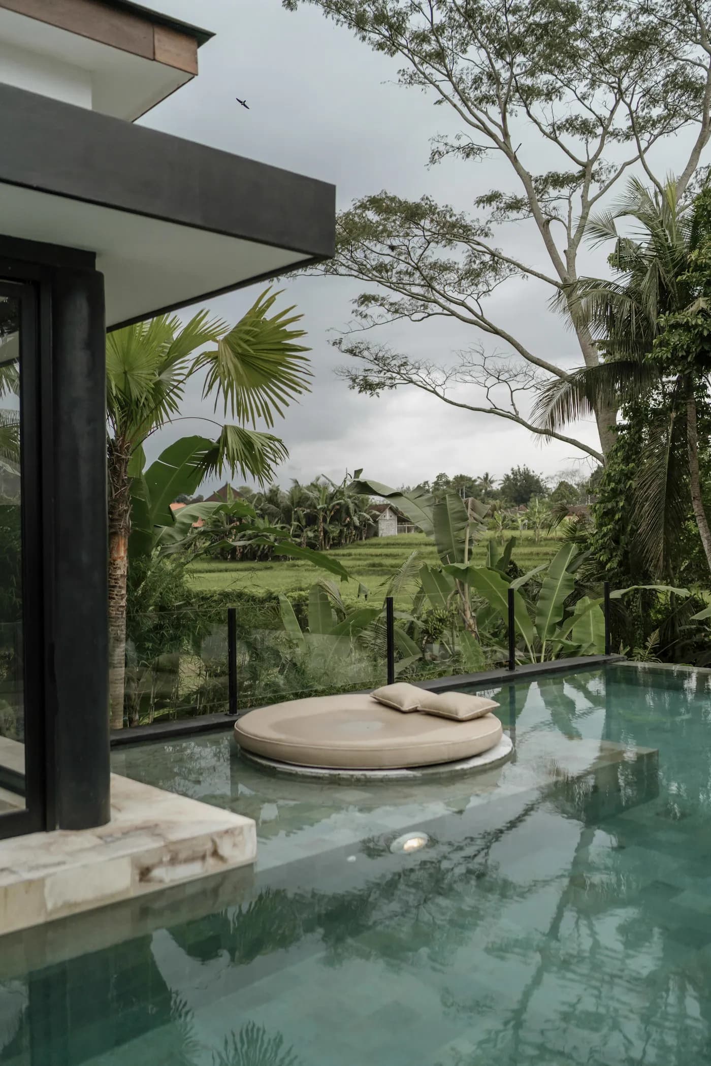 A private Balinese villa with its own pool surrounded by greenery in Ubud, Bali